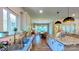 Bright kitchen showcases stainless sink, stone countertops, modern cabinets and flows into a dining area at 3633 Longpond Ln, Monroe, NC 28110