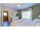 Bright main bedroom featuring wood floors, white walls, and a white dresser by the window at 3633 Longpond Ln, Monroe, NC 28110