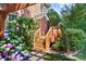 Wooden deck with stairs leading to a pergola, surrounded by lush greenery and flowers at 4009 Oxford Mill Rd, Waxhaw, NC 28173