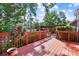 Wooden deck overlooking a landscaped backyard with an outdoor fireplace and pergola at 4009 Oxford Mill Rd, Waxhaw, NC 28173