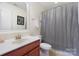 Clean bathroom featuring a neutral color scheme and a shower with gray curtain at 4009 Oxford Mill Rd, Waxhaw, NC 28173