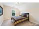 Cozy bedroom with a sloped ceiling and a colorful striped bedspread at 4009 Oxford Mill Rd, Waxhaw, NC 28173