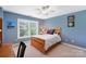 Cozy bedroom with a bright window, ceiling fan, and accent decor at 4009 Oxford Mill Rd, Waxhaw, NC 28173