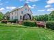 Stunning white clubhouse with watermill feature surrounded by lush landscaping and a pool at 4009 Oxford Mill Rd, Waxhaw, NC 28173