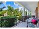 Relaxing covered patio offers a scenic view, stone pillars, and comfortable seating at 4009 Oxford Mill Rd, Waxhaw, NC 28173