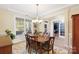 Light-filled dining area featuring wood table and chairs, with a chandelier at 4009 Oxford Mill Rd, Waxhaw, NC 28173