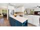 Open-concept kitchen with white cabinets, blue island, and stainless appliances at 4009 Oxford Mill Rd, Waxhaw, NC 28173