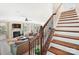 Bright living room with fireplace and stairs leading to upper level with beautiful wood and iron banister at 4009 Oxford Mill Rd, Waxhaw, NC 28173