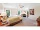 Inviting main bedroom with natural light showcases a bed with soft textures, calm decor, and sitting area at 4009 Oxford Mill Rd, Waxhaw, NC 28173