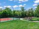 Community tennis courts surrounded by lush landscaping and a paved walking path at 4009 Oxford Mill Rd, Waxhaw, NC 28173
