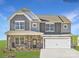 Beautiful new two-story home featuring a stone and shingle facade, covered porch, and attached two-car garage at 4239 Skyboat Cir, Fort Mill, SC 29715