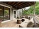 Cozy outdoor deck with comfortable sectional seating and a view of mature green trees at 433-68 W 8Th St, Charlotte, NC 28202