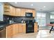 Well-lit kitchen featuring stainless steel appliances, wooden cabinets, and modern backsplash at 433-68 W 8Th St, Charlotte, NC 28202