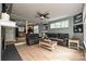 Inviting living room featuring hardwood floors and an open layout to the kitchen with black appliances at 433-68 W 8Th St, Charlotte, NC 28202