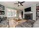 Cozy living room featuring a fireplace, ceiling fan, and ample natural light from the windows at 433-68 W 8Th St, Charlotte, NC 28202