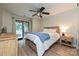 Bright main bedroom featuring a ceiling fan, hardwood floors, and sliding glass doors to a private balcony at 433-68 W 8Th St, Charlotte, NC 28202