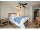Spacious main bedroom with a large bed, wood floors, and a closet with sliding doors at 433-68 W 8Th St, Charlotte, NC 28202