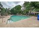Inviting community pool surrounded by lush greenery and lounge chairs for relaxation at 433-68 W 8Th St, Charlotte, NC 28202