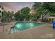 Community swimming pool surrounded by greenery, lounge chairs, and well-maintained landscaping at 433-68 W 8Th St, Charlotte, NC 28202