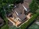 Aerial view of brick house featuring a wooden deck with stairs, and a landscaped backyard at 5104 Top Seed Ct, Charlotte, NC 28226