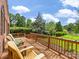Spacious wooden deck with chairs overlooking a serene waterfront view surrounded by lush trees at 5104 Top Seed Ct, Charlotte, NC 28226