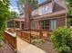 Charming backyard with brick home, deck, screened-in porch, ramp, and mature landscaping at 5104 Top Seed Ct, Charlotte, NC 28226