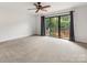 Neutral bedroom with sliding glass doors to a balcony, allowing natural light and outdoor views at 5104 Top Seed Ct, Charlotte, NC 28226
