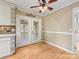 A dining room featuring hardwood floors and French doors that lead to a screened-in porch at 5104 Top Seed Ct, Charlotte, NC 28226