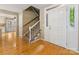 Inviting foyer with hardwood floors, staircase, and a bright white front door at 5104 Top Seed Ct, Charlotte, NC 28226
