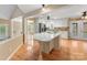 Bright kitchen with a large island, hardwood floors, stainless steel appliances, and white cabinetry at 5104 Top Seed Ct, Charlotte, NC 28226