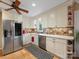 Well-lit kitchen with modern appliances, tile backsplash, and open shelving at 5104 Top Seed Ct, Charlotte, NC 28226
