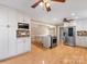 Spacious kitchen featuring an island, stainless steel appliances, hardwood floors, and white cabinetry at 5104 Top Seed Ct, Charlotte, NC 28226