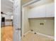 Laundry room next to the kitchen with built-in storage and tiled floors at 5104 Top Seed Ct, Charlotte, NC 28226