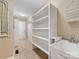 Laundry room with built-in storage and sink with tiled floors and neutral paint at 5104 Top Seed Ct, Charlotte, NC 28226