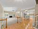 Open concept living room and kitchen featuring hardwood floors, fireplace, and a center island at 5104 Top Seed Ct, Charlotte, NC 28226
