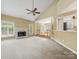 Spacious living room featuring a white brick fireplace, vaulted ceiling, and seamless transition to dining area at 5104 Top Seed Ct, Charlotte, NC 28226