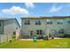 This open backyard features a well-maintained lawn, patio seating, and a grill for outdoor gatherings at 5334 Orchid Bloom Dr, Fort Mill, SC 29707