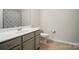 Clean bathroom featuring a modern vanity with a sleek sink and fixtures, alongside a toilet at 5334 Orchid Bloom Dr, Fort Mill, SC 29707