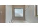 Soaking tub in bathroom featuring chrome fixtures, a frosted window, and neutral wall color, towel rack at 5334 Orchid Bloom Dr, Fort Mill, SC 29707