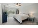 Spacious primary bedroom with tray ceiling, neutral decor, lots of natural light, and a light-colored carpet at 5334 Orchid Bloom Dr, Fort Mill, SC 29707