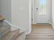 Bright entryway with hardwood floors, white trim, and a modern front door at 5334 Orchid Bloom Dr, Fort Mill, SC 29707