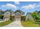 Inviting two-story townhome featuring a one-car garage, brick accents, and landscaped front yard at 5334 Orchid Bloom Dr, Fort Mill, SC 29707
