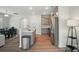 Open-concept kitchen flows into dining area, featuring stainless steel appliances and hardwood floors at 5334 Orchid Bloom Dr, Fort Mill, SC 29707