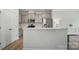 Charming kitchen with stainless steel appliances, tiled backsplash, and white countertop breakfast bar at 5334 Orchid Bloom Dr, Fort Mill, SC 29707