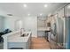 Open-concept kitchen with stainless steel appliances, stylish cabinets, and hardwood floors at 5334 Orchid Bloom Dr, Fort Mill, SC 29707