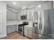 Well-lit kitchen features stainless steel appliances, white countertops, and modern cabinetry at 5334 Orchid Bloom Dr, Fort Mill, SC 29707