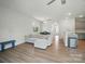 Open-concept living room with hardwood floors, a cozy couch, and ample natural light at 5334 Orchid Bloom Dr, Fort Mill, SC 29707