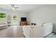 Well-lit living room boasts hardwood floors, comfortable seating, and a modern ceiling fan at 5334 Orchid Bloom Dr, Fort Mill, SC 29707