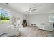 Bright living room with hardwood floors, ceiling fan, and sliding glass door at 5334 Orchid Bloom Dr, Fort Mill, SC 29707