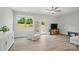 Sunlit living room featuring hardwood floors, ceiling fan, and a neutral color palette at 5334 Orchid Bloom Dr, Fort Mill, SC 29707